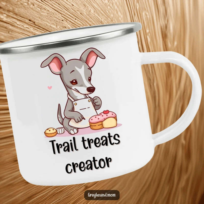 Funny Greyhound baker camping mug with a slender dog in an apron, delicately decorating a tiny pastry, ideal for outdoor enjoyment.