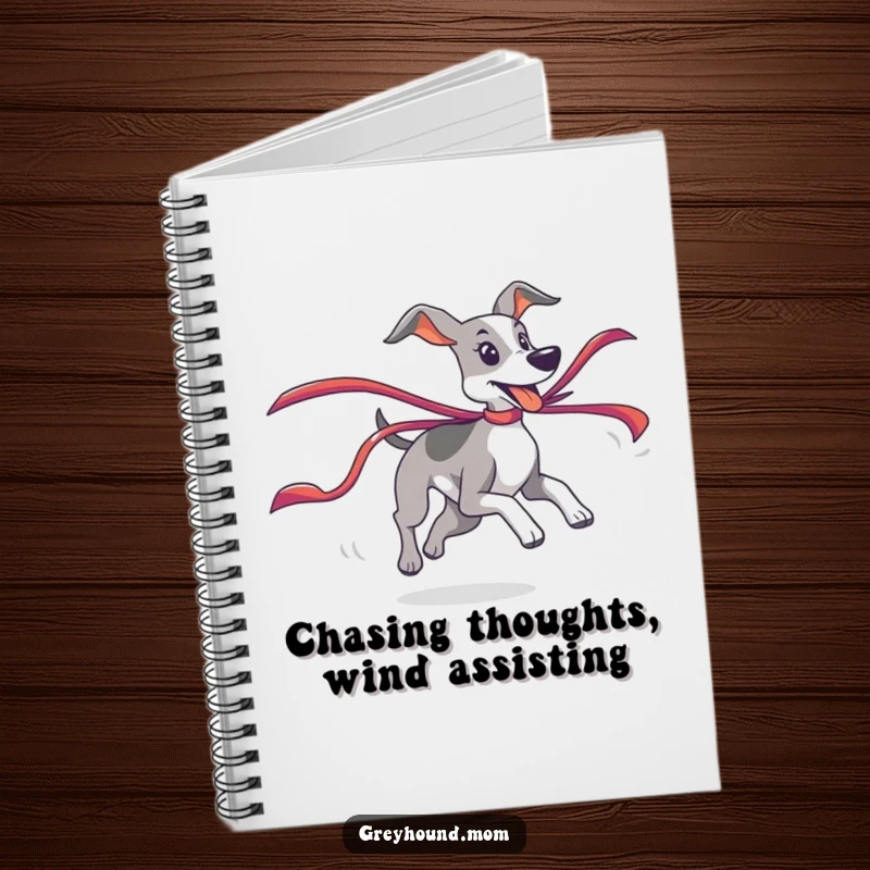 Funny Greyhound Notebook depicting a playful chase of a colorful ribbon, perfect for journaling and gifts.