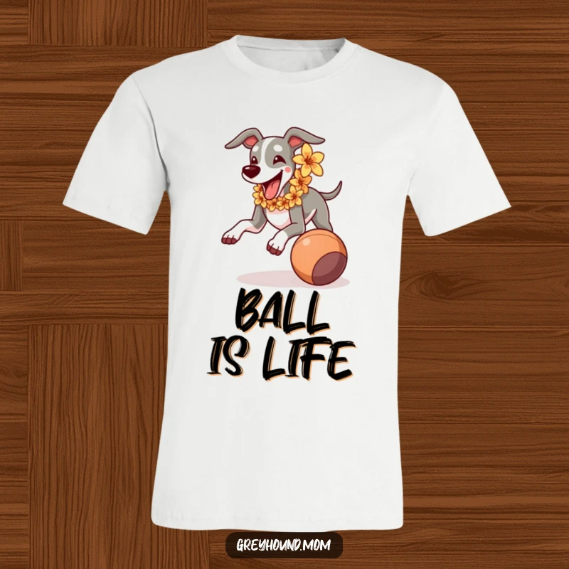 Funny Greyhound with flower lei running joyfully after a rolling ball, a hilarious graphic tee for dog lovers.