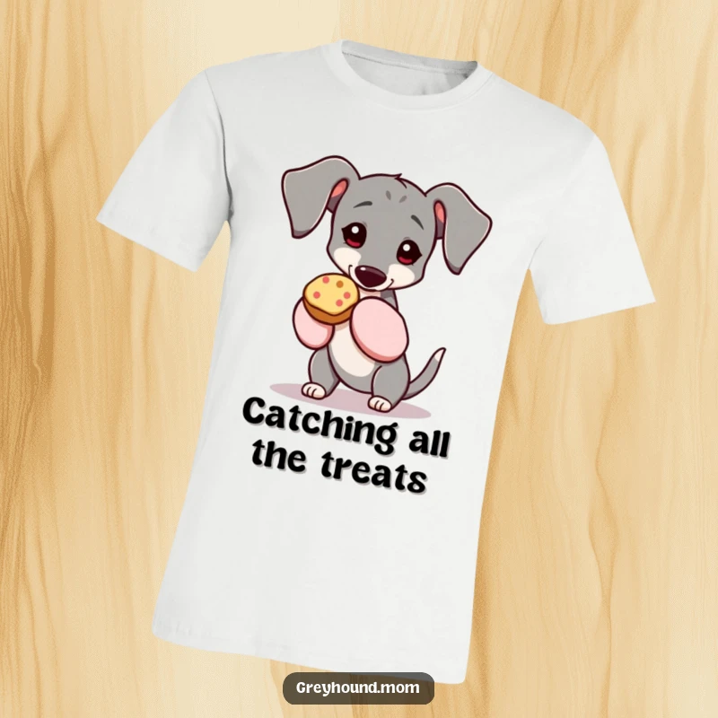 Funny Greyhound t-shirt, the dog is wearing oven mitts and holding a tempting treat, looking pleased with itself. Ideal funny gift for dog parents.
